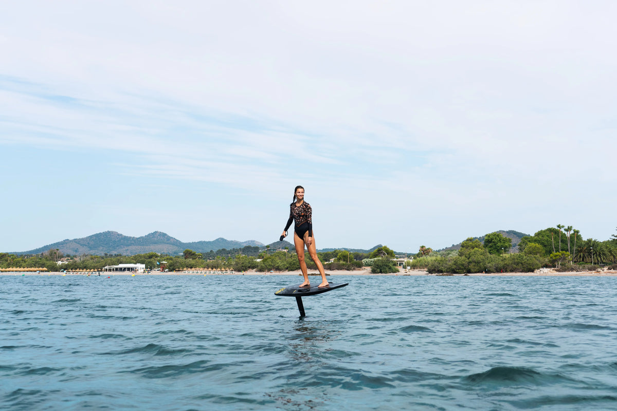 Rider gliding calmly on an Aerofoils Performance eFoil in Carbon Camo off the Mallorca coast, the kind of easy last session before off-season storage