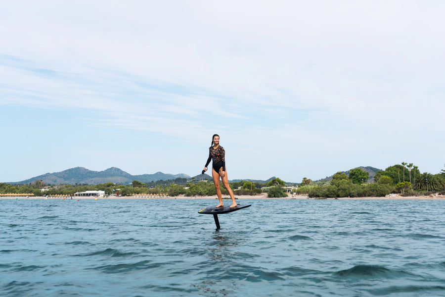 Rider gliding calmly on an Aerofoils Performance eFoil in Carbon Camo off the Mallorca coast, the kind of easy last session before off-season storage